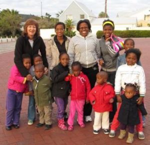 Penny (left) and Ella (2nd from right) with some of the children they care for.